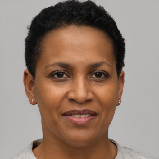 Joyful black adult female with short  brown hair and brown eyes