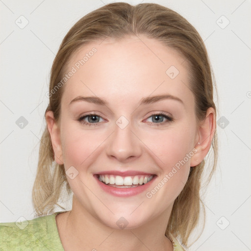 Joyful white young-adult female with medium  brown hair and blue eyes