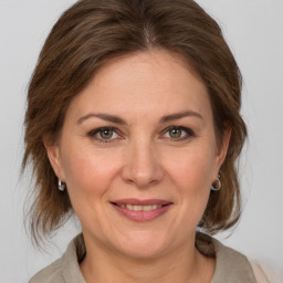 Joyful white adult female with medium  brown hair and grey eyes