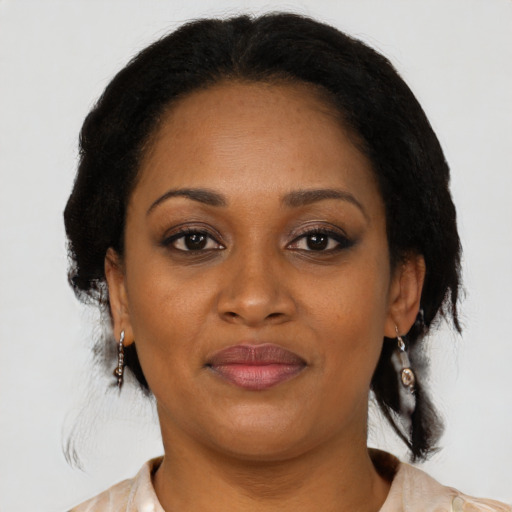 Joyful black adult female with medium  brown hair and brown eyes