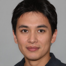 Joyful asian young-adult male with short  black hair and brown eyes