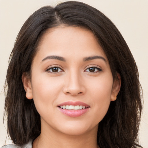 Joyful white young-adult female with long  brown hair and brown eyes