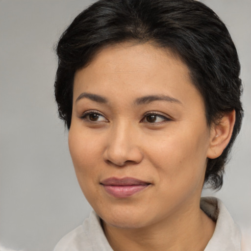 Joyful asian young-adult female with medium  brown hair and brown eyes