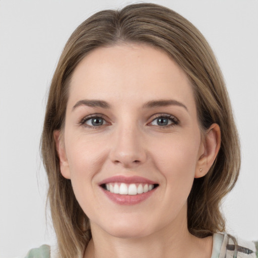 Joyful white young-adult female with medium  brown hair and green eyes