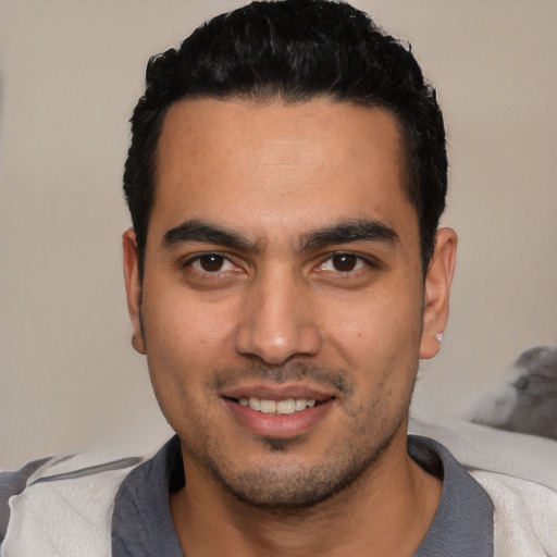 Joyful white young-adult male with short  black hair and brown eyes