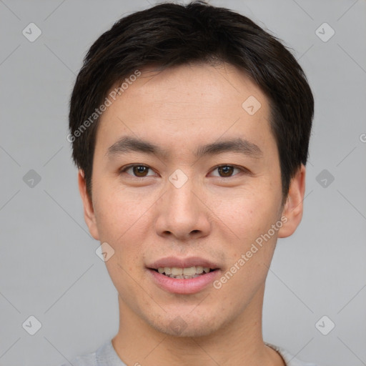 Joyful asian young-adult male with short  brown hair and brown eyes