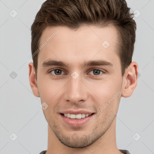 Joyful white young-adult male with short  brown hair and brown eyes