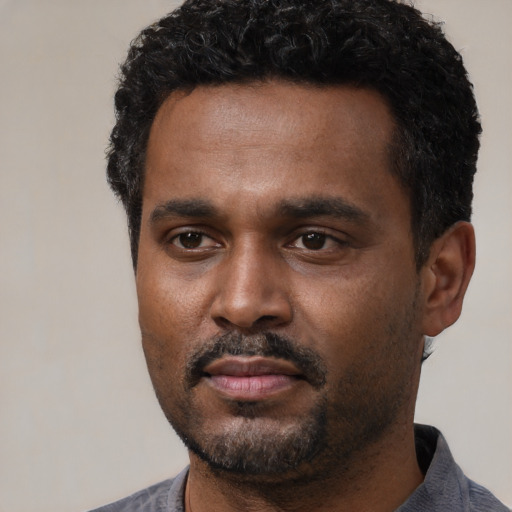 Neutral latino adult male with short  black hair and brown eyes