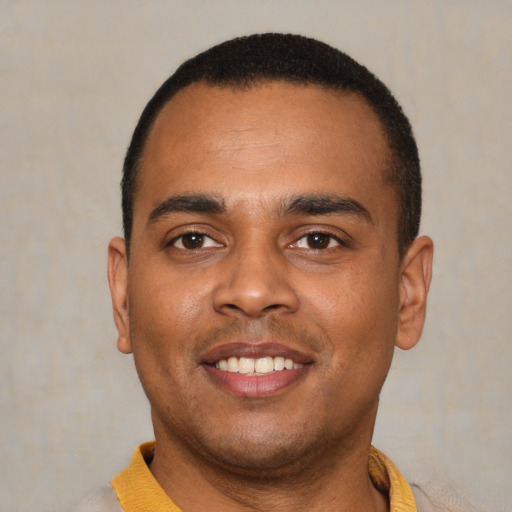 Joyful latino young-adult male with short  black hair and brown eyes