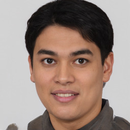 Joyful asian young-adult male with short  black hair and brown eyes