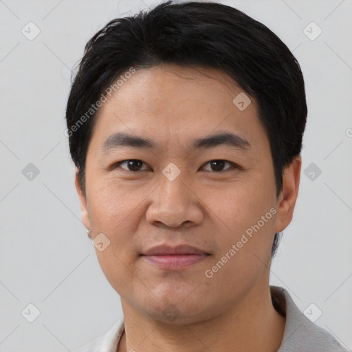 Joyful asian young-adult male with short  black hair and brown eyes