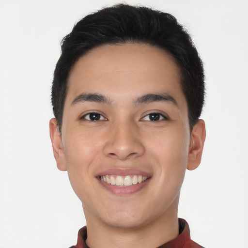 Joyful latino young-adult male with short  brown hair and brown eyes