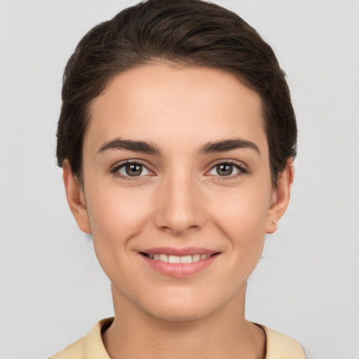 Joyful white young-adult female with short  brown hair and brown eyes