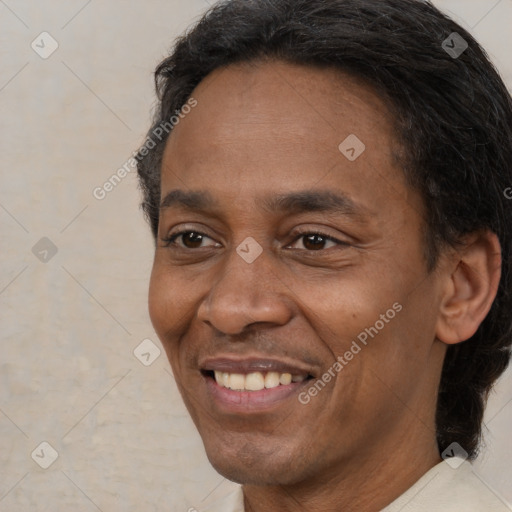 Joyful black adult male with short  black hair and brown eyes