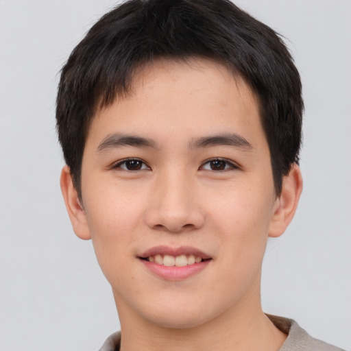 Joyful asian young-adult male with short  brown hair and brown eyes