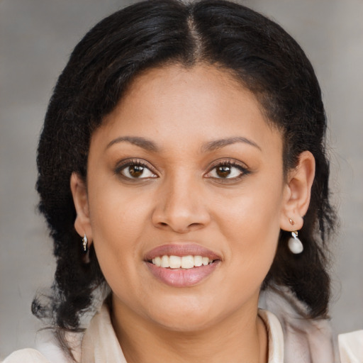 Joyful black young-adult female with medium  brown hair and brown eyes