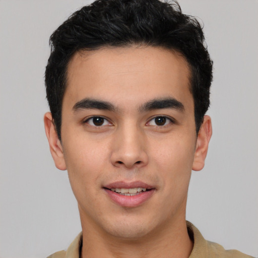 Joyful white young-adult male with short  black hair and brown eyes