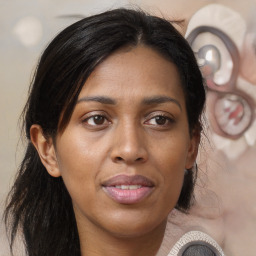 Joyful black young-adult female with long  brown hair and brown eyes