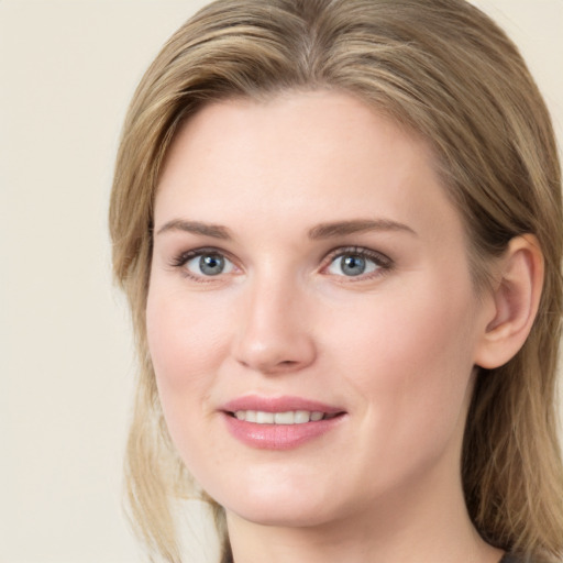 Joyful white young-adult female with medium  brown hair and green eyes