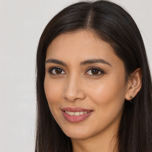 Joyful latino young-adult female with long  brown hair and brown eyes