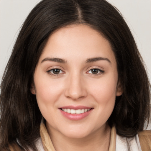 Joyful white young-adult female with medium  brown hair and brown eyes