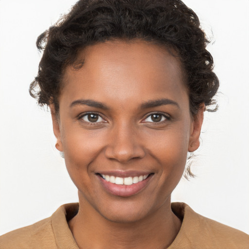 Joyful black young-adult female with short  brown hair and brown eyes