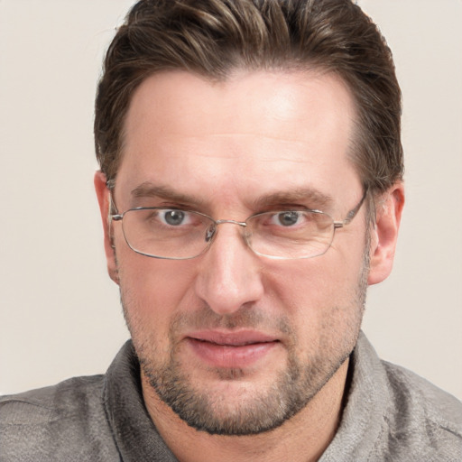 Joyful white adult male with short  brown hair and grey eyes