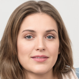 Joyful white young-adult female with long  brown hair and green eyes