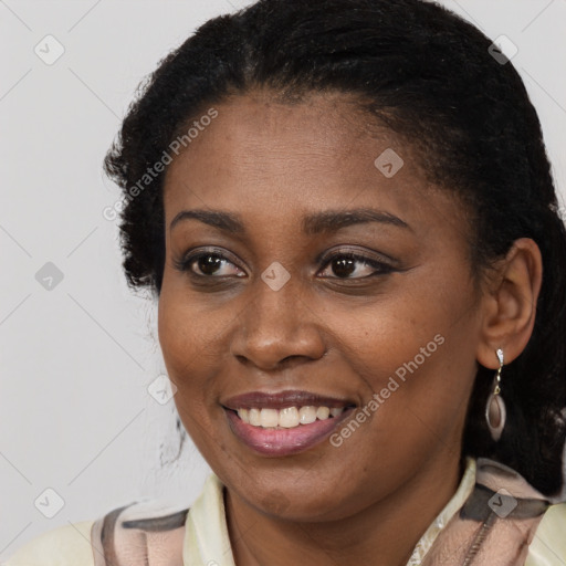 Joyful black young-adult female with short  brown hair and brown eyes