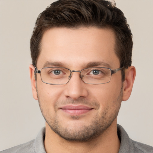 Joyful white adult male with short  brown hair and brown eyes