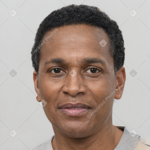 Joyful latino adult male with short  black hair and brown eyes