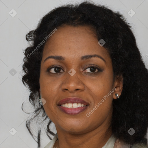 Joyful black adult female with long  brown hair and brown eyes