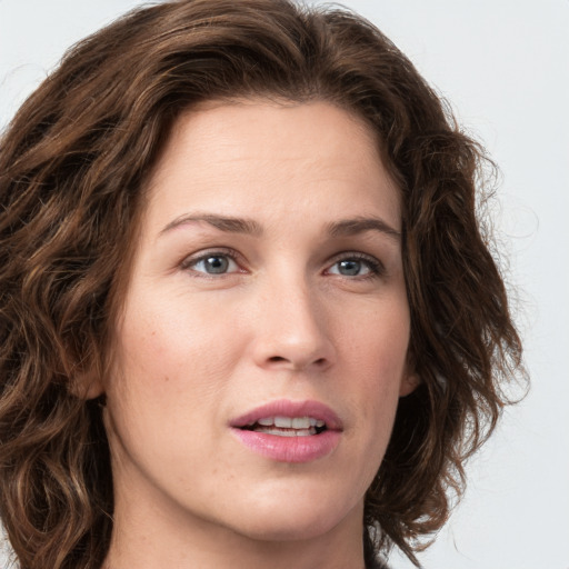 Joyful white young-adult female with medium  brown hair and green eyes