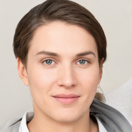 Joyful white young-adult female with short  brown hair and grey eyes