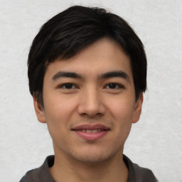 Joyful asian young-adult male with short  black hair and brown eyes