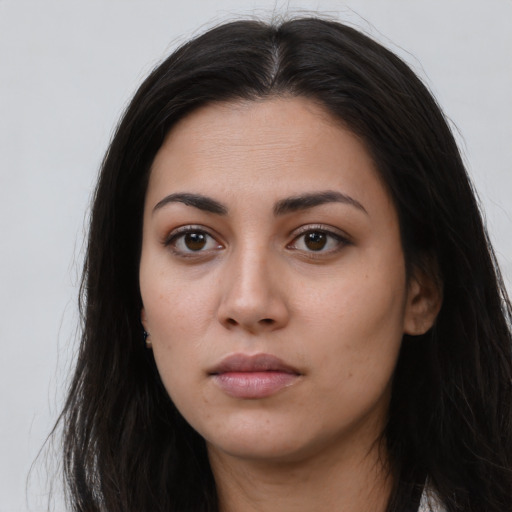 Neutral latino young-adult female with long  brown hair and brown eyes