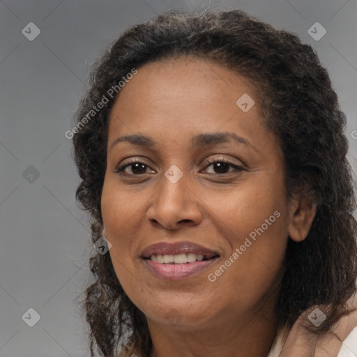 Joyful black adult female with medium  brown hair and brown eyes