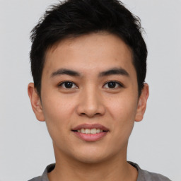 Joyful asian young-adult male with short  black hair and brown eyes