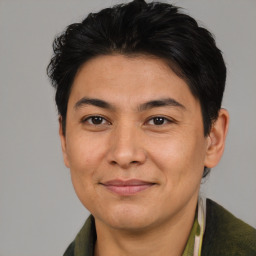 Joyful asian young-adult male with short  brown hair and brown eyes