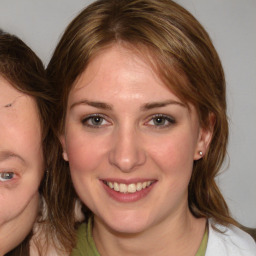 Joyful white young-adult female with medium  brown hair and blue eyes