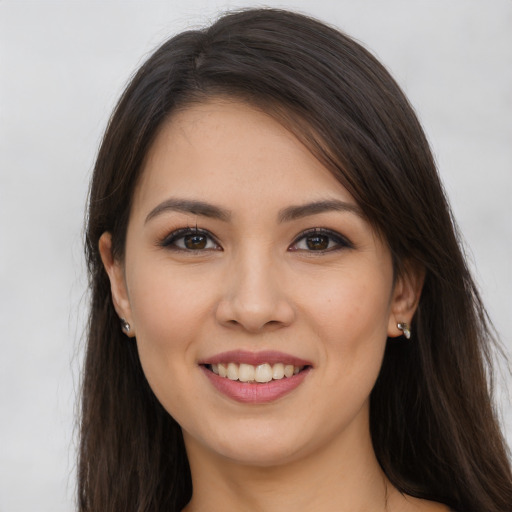 Joyful white young-adult female with long  brown hair and brown eyes