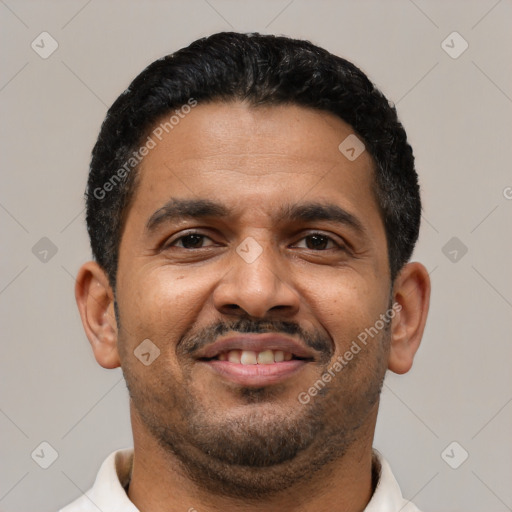 Joyful latino adult male with short  black hair and brown eyes