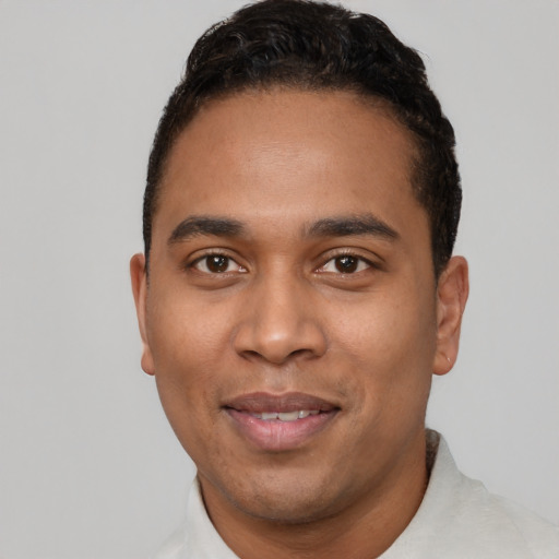 Joyful latino young-adult male with short  black hair and brown eyes