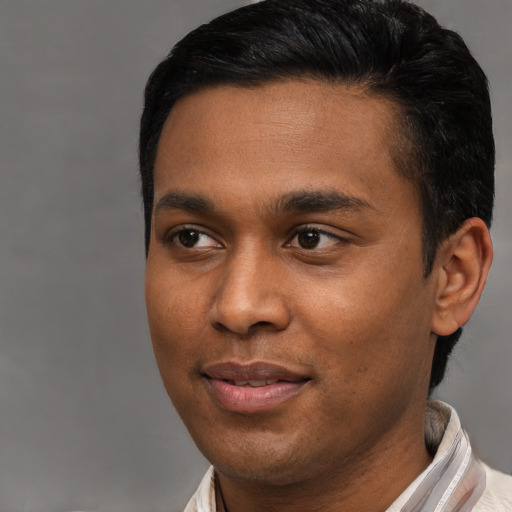 Joyful latino young-adult male with short  black hair and brown eyes