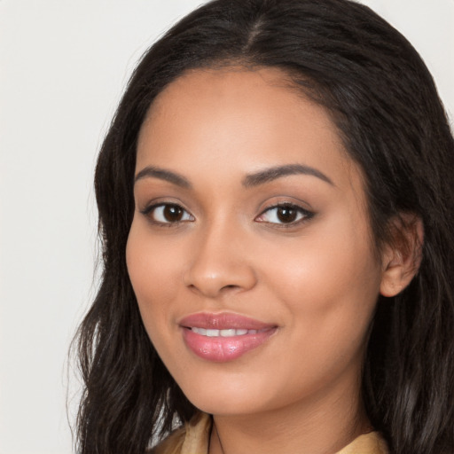 Joyful latino young-adult female with long  black hair and brown eyes