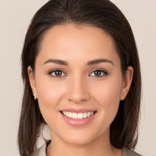 Joyful white young-adult female with long  brown hair and brown eyes