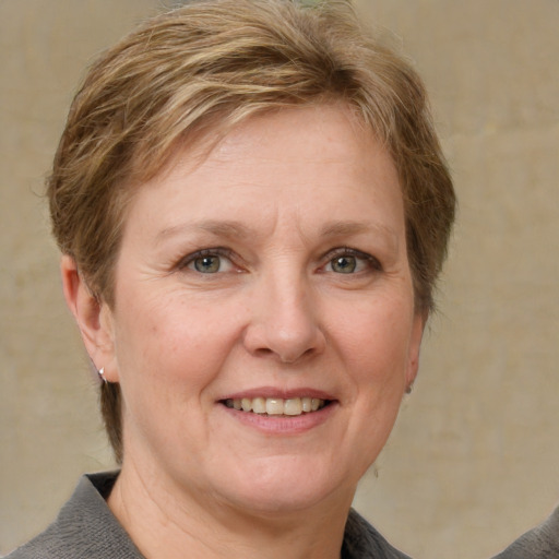 Joyful white adult female with short  brown hair and grey eyes