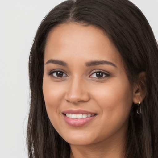 Joyful white young-adult female with long  brown hair and brown eyes