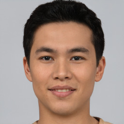 Joyful asian young-adult male with short  black hair and brown eyes