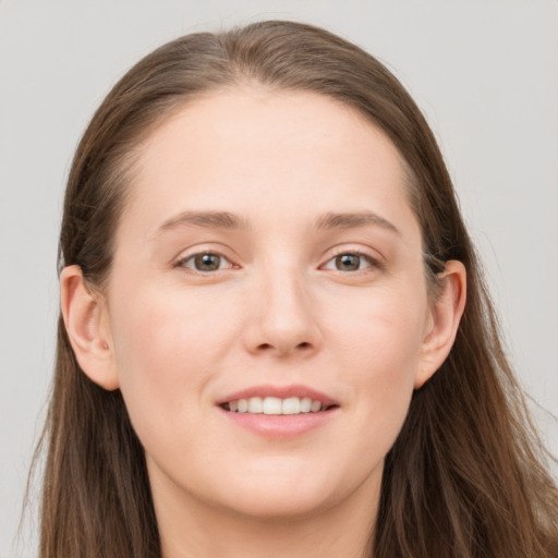 Joyful white young-adult female with long  brown hair and grey eyes